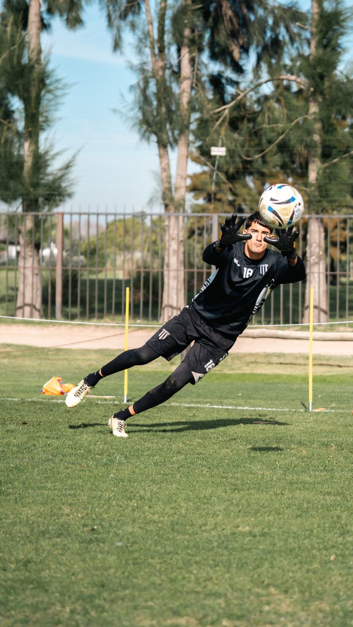 services-09 Goalkeeper making a dynamic save during soccer practice outdoors.
