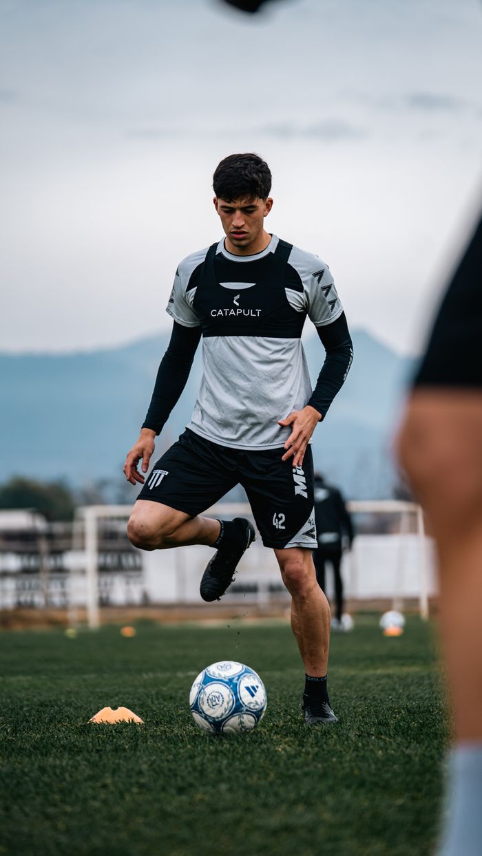 about-01 Focused soccer player practicing with ball during outdoor training session.